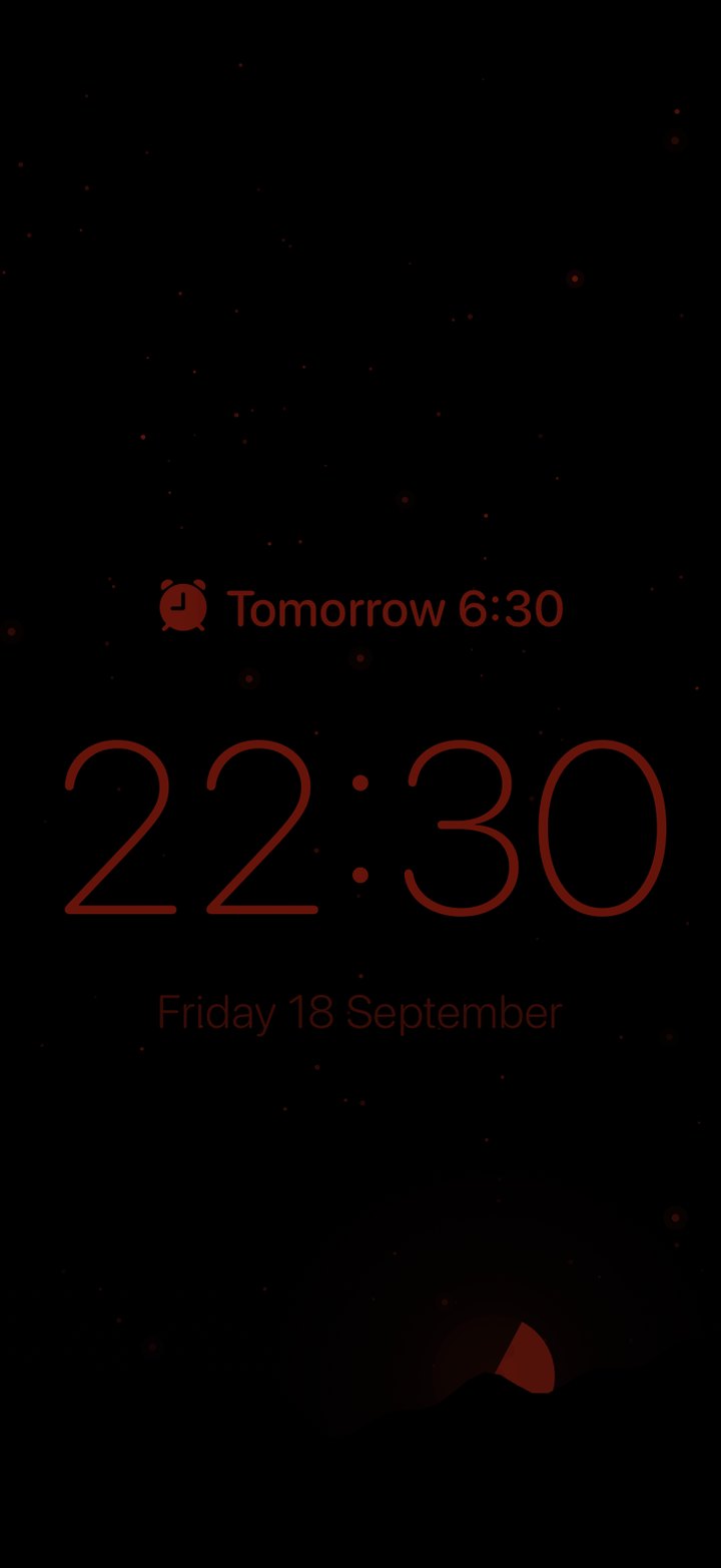 The night display: a dim red clock on black.