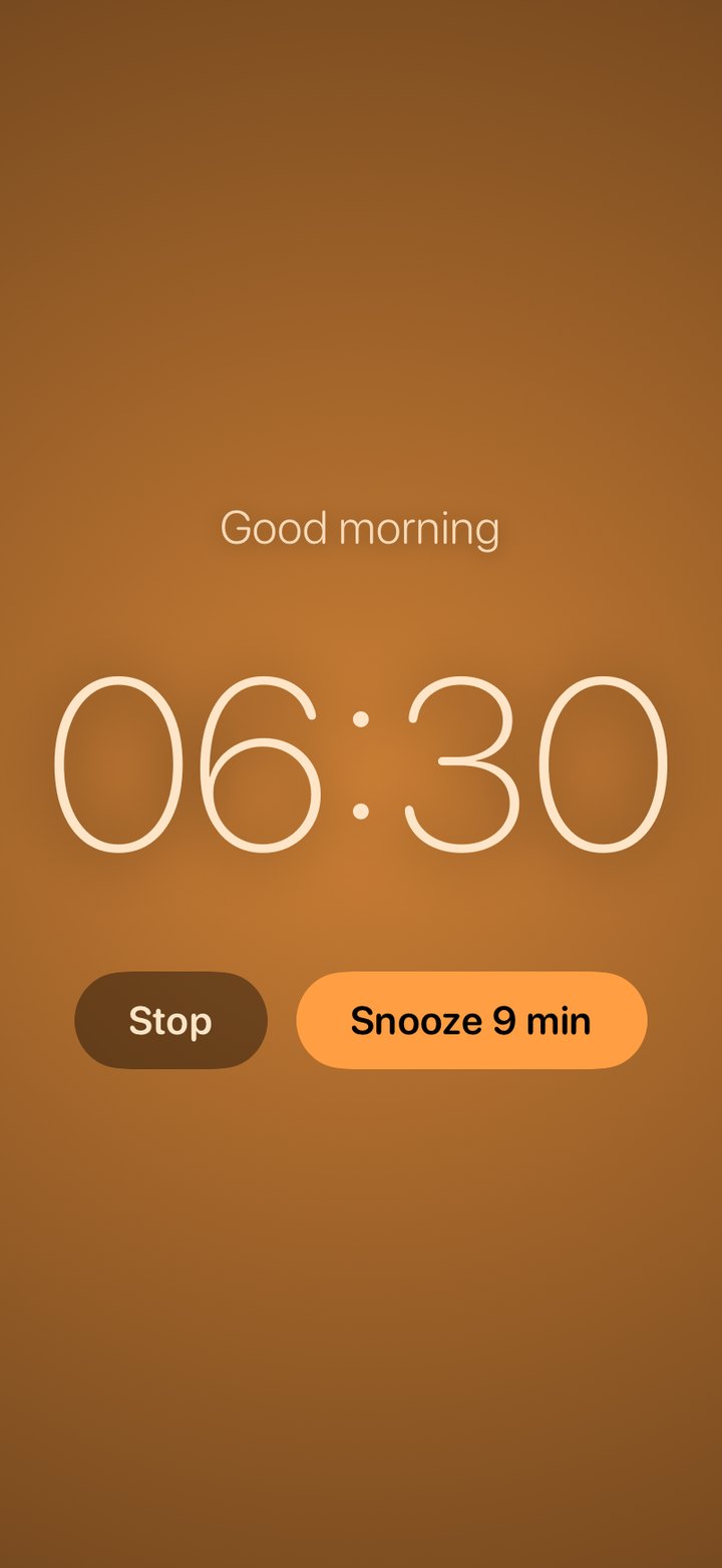 The wake light: the whole screen glows amber with the time and two buttons, Stop and Snooze.